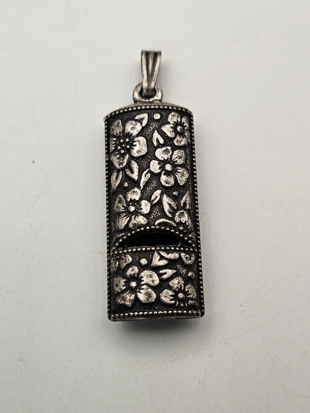 Vintage 1975 Avon Silver Note Whistle Pendant Embossed Floral Silver Tone